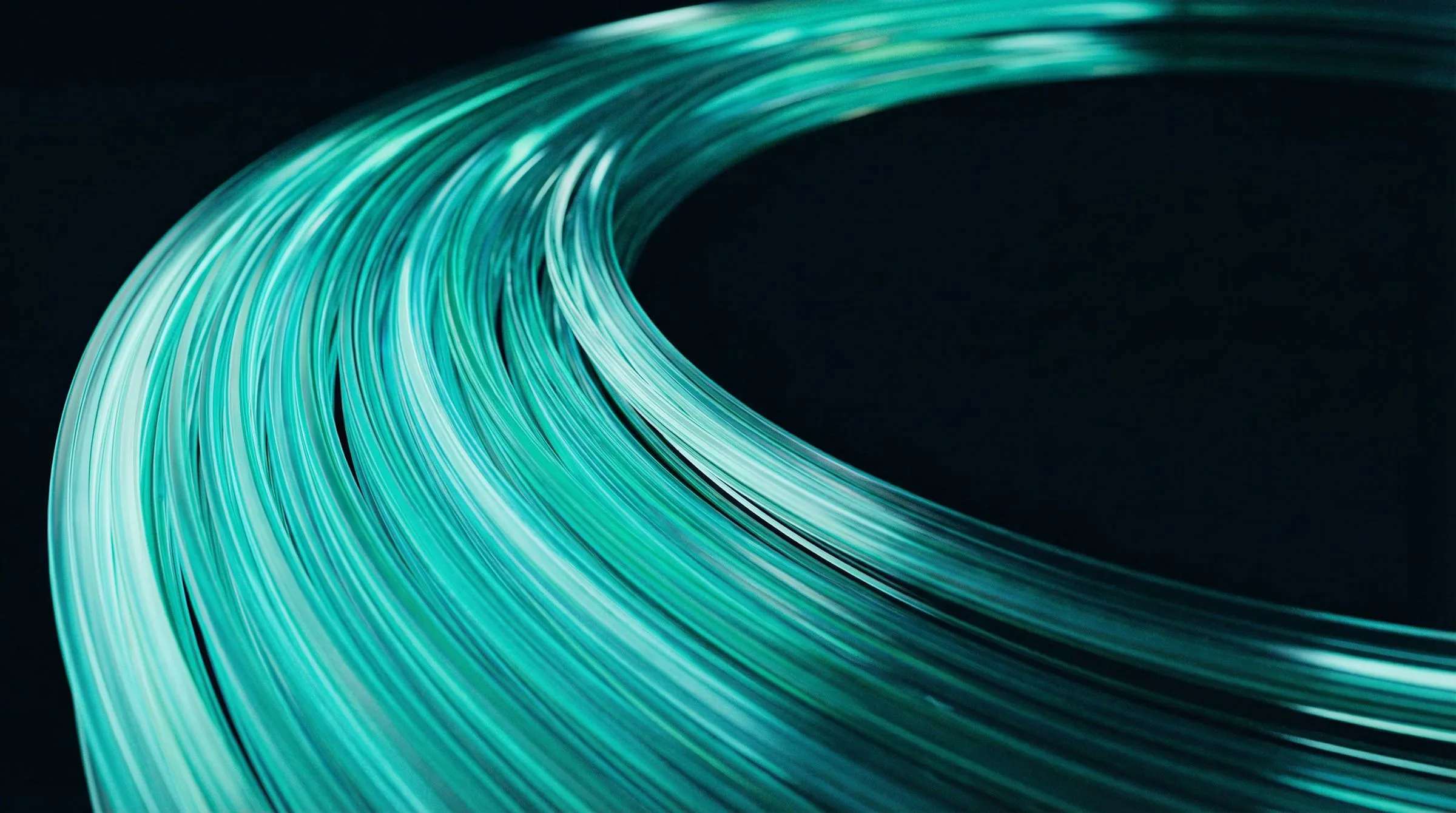 Bundle of glowing teal optical fibers curving through darkness, evoking photonics and the flow of data in deep tech.